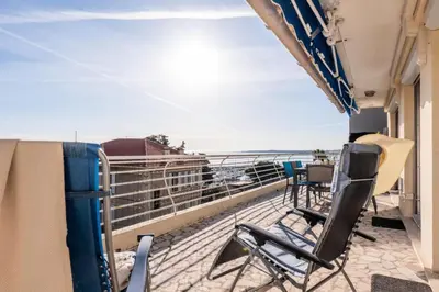 a balcony with chairs and a view of the ocean at Résidence 4p Avec Terrasse Vue Mer à Deux Pas Des Plages - 4P avec terrasse vue mer à deux pas des plages MAE-2593 in Cannes