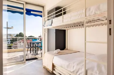 a bedroom with bunk beds and a balcony at Résidence 4p Avec Terrasse Vue Mer à Deux Pas Des Plages - 4P avec terrasse vue mer à deux pas des plages MAE-2593 in Cannes