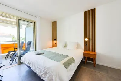 a bedroom with a large bed and a balcony at Résidence 2p Rénové, Terrasse Et Plage à Pied - 2P rénové, terrasse et plage à pied MAE-2623 in Cannes