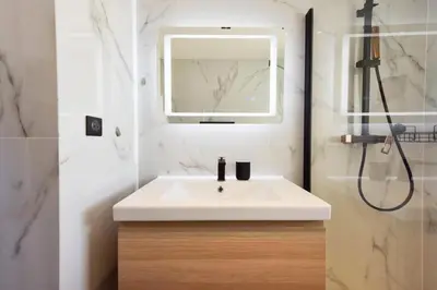 a bathroom with a white sink and a shower at Résidence 2p Rénové, Terrasse Et Plage à Pied - 2P rénové, terrasse et plage à pied MAE-2623 in Cannes