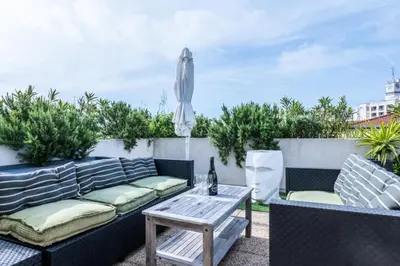 a patio with a couch and an umbrella and a table at Résidence Rare ! Rooftop 120m² 5min à Pied Du Centre - RARE ! ROOFTOP 120m² 5min à pied du centre MAE-2643 in Cannes