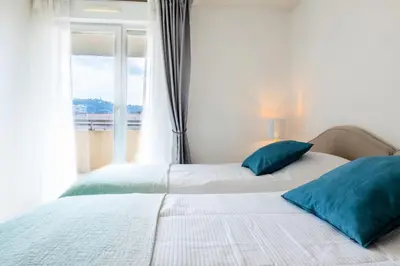 two beds with blue pillows in a bedroom with a window at Résidence Rare ! Rooftop 120m² 5min à Pied Du Centre - RARE ! ROOFTOP 120m² 5min à pied du centre MAE-2643 in Cannes
