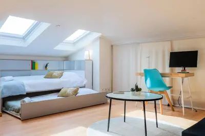a bedroom with a bed and a table and a chair at Résidence Rare ! Rooftop 120m² 5min à Pied Du Centre - RARE ! ROOFTOP 120m² 5min à pied du centre MAE-2643 in Cannes