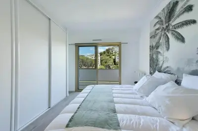 a bedroom with a large bed and a large window at Résidence 3p Vue Mer, Plages à Pied & Parking Privé. - 3P vue mer, plages à pied & parking privé. MAE-2663 in Cannes