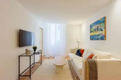 a living room with a white couch and a tv at Résidence 2p De Standing à 100m Du Palais - 2p de standing à 100m du Palais MAE-2683 in Cannes