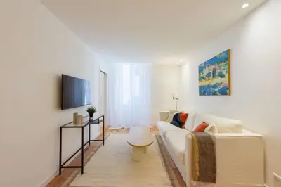 a living room with a white couch and a tv at Résidence 2p De Standing à 100m Du Palais - 2p de standing à 100m du Palais MAE-2683 in Cannes