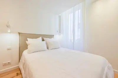 a white bed with white pillows in a bedroom at Résidence 2p De Standing à 100m Du Palais - 2p de standing à 100m du Palais MAE-2683 in Cannes