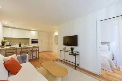 a living room with a couch and a kitchen at Résidence 2p De Standing à 100m Du Palais - 2p de standing à 100m du Palais MAE-2683 in Cannes