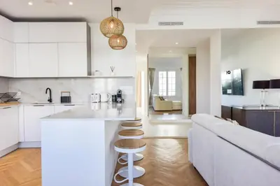 a kitchen and living room with a couch and a counter at Résidence Rare 4p Standing Proche Croisette - Rare 4P standing proche Croisette MAE-2713 in Cannes