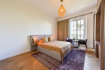 a bedroom with a bed and a table and a window at Résidence Rare 4p Standing Proche Croisette - Rare 4P standing proche Croisette MAE-2713 in Cannes