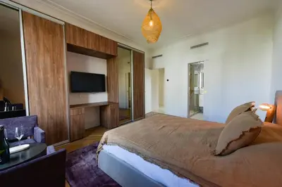 a large bedroom with a large bed and a tv at Résidence Rare 4p Standing Proche Croisette - Rare 4P standing proche Croisette MAE-2713 in Cannes