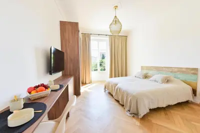 a bedroom with a bed and a desk with a television at Résidence Rare 4p Standing Proche Croisette - Rare 4P standing proche Croisette MAE-2713 in Cannes