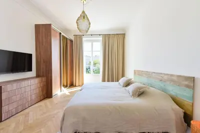 a bedroom with a large bed and a flat screen tv at Résidence Rare 4p Standing Proche Croisette - Rare 4P standing proche Croisette MAE-2713 in Cannes