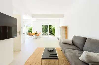 a living room with a couch and a table at Résidence Rez-de-jardin, Plages à Pied Et Garage - Rez-de-jardin, plages à pied et garage MAE-2723 in Cannes