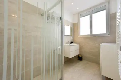 a bathroom with a glass shower and a sink at Résidence Rez-de-jardin, Plages à Pied Et Garage - Rez-de-jardin, plages à pied et garage MAE-2723 in Cannes