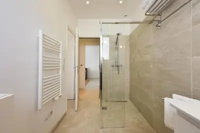 a bathroom with a shower and a glass shower stall at Résidence Rez-de-jardin, Plages à Pied Et Garage - Rez-de-jardin, plages à pied et garage MAE-2723 in Cannes