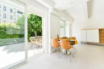 a dining room with a table and chairs and sliding glass doors at Résidence Rez-de-jardin, Plages à Pied Et Garage - Rez-de-jardin, plages à pied et garage MAE-2723 in Cannes