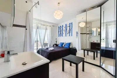 a bedroom with a bed and a bathroom with a sink at Résidence Cosy 3p En Dernier étage, Terrasse Et Vue Mer - Cosy 3P en dernier étage, terrasse et vue mer MAE-2733 in Cannes