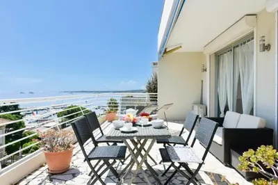 a patio with a table and chairs on a balcony at Résidence Cosy 3p En Dernier étage, Terrasse Et Vue Mer - Cosy 3P en dernier étage, terrasse et vue mer MAE-2733 in Cannes