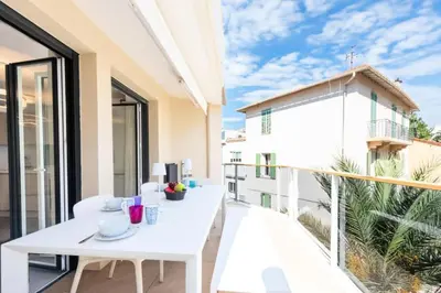 a balcony with a white table and chairs on it at Résidence 3p Piscine, Parking Et Plages à 100m - 3P piscine, parking et plages à 100m MAE-2763 in Cannes