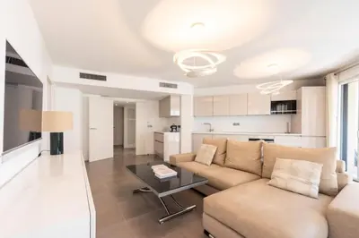 a living room with a couch and a table at Résidence 3p Piscine, Parking Et Plages à 100m - 3P piscine, parking et plages à 100m MAE-2763 in Cannes