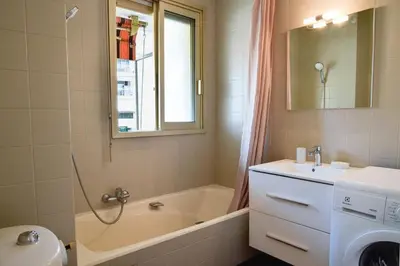 a bathroom with a tub and a sink and a washing machine at Résidence Palm Beach Studio Avec Terrasse A 150m Des Plages - Palm Beach studio avec terrasse a 150m des plages MAE-2773 in Cannes