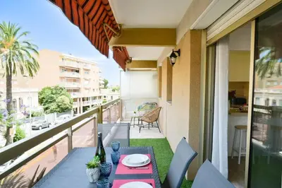 a balcony with a table and a view of a city at Résidence Palm Beach Studio Avec Terrasse A 150m Des Plages - Palm Beach studio avec terrasse a 150m des plages MAE-2773 in Cannes