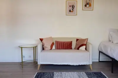 a living room with a couch and a table at Résidence Palm Beach Studio Avec Terrasse A 150m Des Plages - Palm Beach studio avec terrasse a 150m des plages MAE-2773 in Cannes