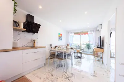 a kitchen with a table and a dining room at Résidence 2p Rénové Proche Croisette - 2P Rénové proche Croisette MAE-2783 in Cannes