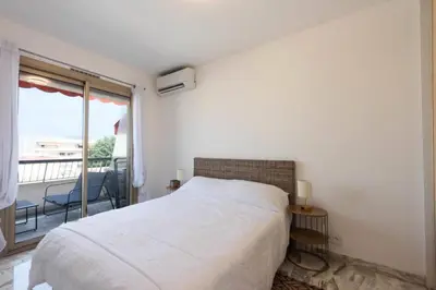 a white bedroom with a bed and a balcony at Résidence 2p Rénové Proche Croisette - 2P Rénové proche Croisette MAE-2783 in Cannes
