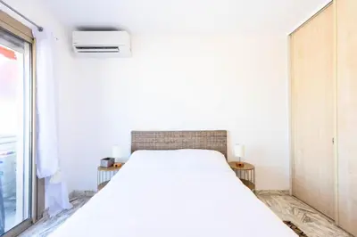 a white bedroom with a bed and a window at Résidence 2p Rénové Proche Croisette - 2P Rénové proche Croisette MAE-2783 in Cannes