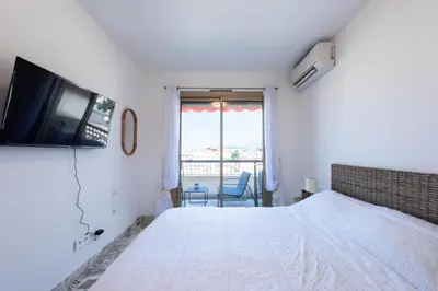 a bedroom with a bed and a tv on the wall at Résidence 2p Rénové Proche Croisette - 2P Rénové proche Croisette MAE-2783 in Cannes