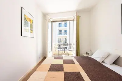 a bedroom with a bed and a window with a table at Résidence Cannes 2p Carré D’or - Cannes 2p Carré d’Or MAE-2793 in Cannes