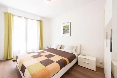 a bedroom with a bed with a checkered blanket at Résidence Cannes 2p Carré D’or - Cannes 2p Carré d’Or MAE-2793 in Cannes