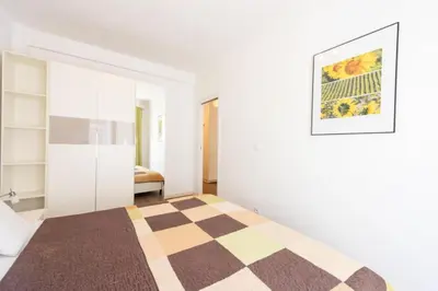 a bedroom with a checkered rug on a bed at Résidence Cannes 2p Carré D’or - Cannes 2p Carré d’Or MAE-2793 in Cannes