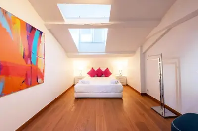 a bedroom with a bed and a painting on the wall at Résidence Beau 2 Pièces à 3 Min De La Croisette - Beau 2 Pièces à 3 min de la Croisette MAE-2803 in Cannes