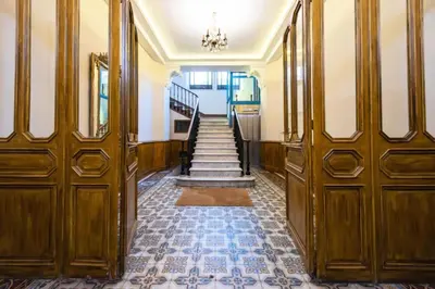a hallway with wooden doors and stairs in a building at Résidence Beau 2 Pièces à 3 Min De La Croisette - Beau 2 Pièces à 3 min de la Croisette MAE-2803 in Cannes