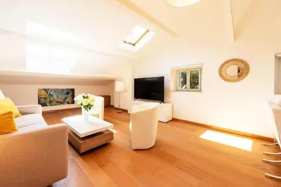 a living room with a couch and a tv at Résidence Beau 2 Pièces à 3 Min De La Croisette - Beau 2 Pièces à 3 min de la Croisette MAE-2803 in Cannes