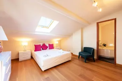 a bedroom with a bed and a chair and a skylight at Résidence Superbe 3 Pièces à 3 Min De La Croisette - Superbe 3 Pièces à 3 min de la Croisette MAE-2813 in Cannes