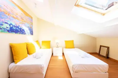 a room with two beds and a painting on the wall at Résidence Superbe 3 Pièces à 3 Min De La Croisette - Superbe 3 Pièces à 3 min de la Croisette MAE-2813 in Cannes