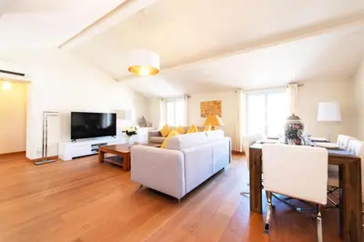 a living room with a white couch and a tv at Résidence Superbe 3 Pièces à 3 Min De La Croisette - Superbe 3 Pièces à 3 min de la Croisette MAE-2813 in Cannes