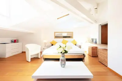 a bedroom with a bed and a vase of flowers on a table at Résidence Grand Studio à 3 Min De La Croisette - Grand Studio à 3 min de la Croisette MAE-2823 in Cannes