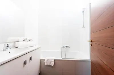 a white bathroom with a sink and a mirror at Résidence Grand Studio à 3 Min De La Croisette - Grand Studio à 3 min de la Croisette MAE-2823 in Cannes