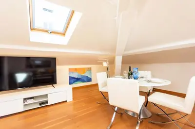 a living room with a dining table and a television at Résidence Grand Studio à 3 Min De La Croisette - Grand Studio à 3 min de la Croisette MAE-2823 in Cannes