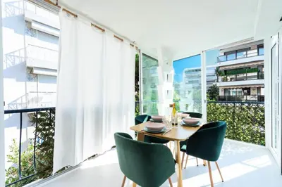 a dining room with a table and chairs and a large window at Résidence Lumineux 2p, Plages à Pied - Lumineux 2P, plages à pied MAE-2843 in Cannes