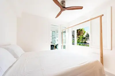 a bedroom with a white bed and a ceiling fan at Résidence Lumineux 2p, Plages à Pied - Lumineux 2P, plages à pied MAE-2843 in Cannes