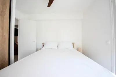 a bedroom with a white bed in a white room at Résidence Lumineux 2p, Plages à Pied - Lumineux 2P, plages à pied MAE-2843 in Cannes