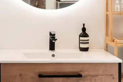 a bottle of wine sits on a bathroom sink at Résidence Lumineux 2p, Plages à Pied - Lumineux 2P, plages à pied MAE-2843 in Cannes