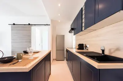 a kitchen with black cabinets and a sink at Résidence Lumineux 2p, Plages à Pied - Lumineux 2P, plages à pied MAE-2843 in Cannes