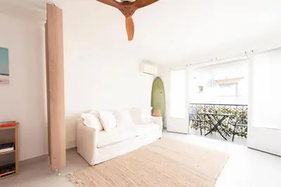 a living room with a white couch and a large window at Résidence Lumineux 2p, Plages à Pied - Lumineux 2P, plages à pied MAE-2843 in Cannes